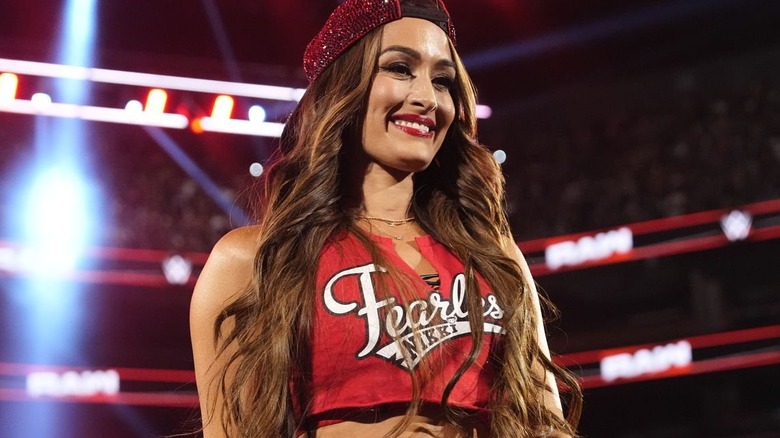 Nikki Bella smiles as she re-enters a ring on an episode of 