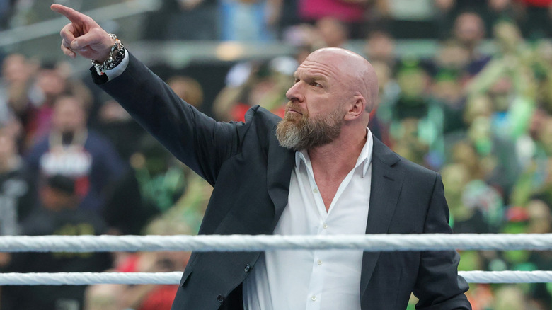 WWE CCO Triple H does the iconic finger point at the WrestleMania sign as he welcomes fans to "The Grandest Stage of Them All"