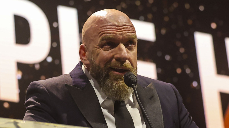 Triple H speaking behind a podium