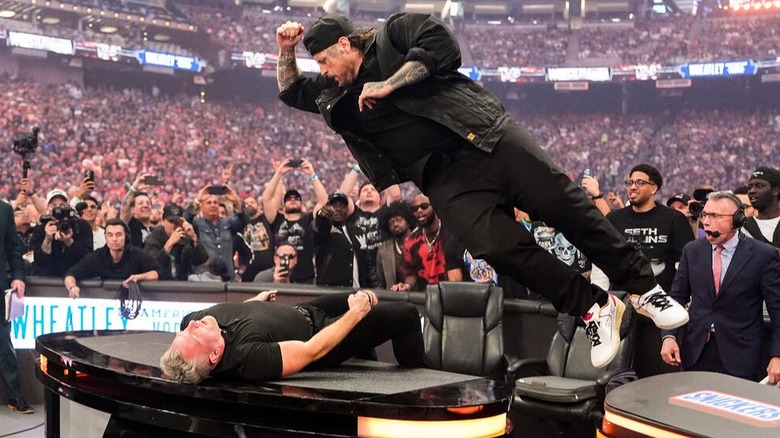 Jelly Roll connects and elbow drop on Pat McAfee on the commentary table at WrestleMania 42