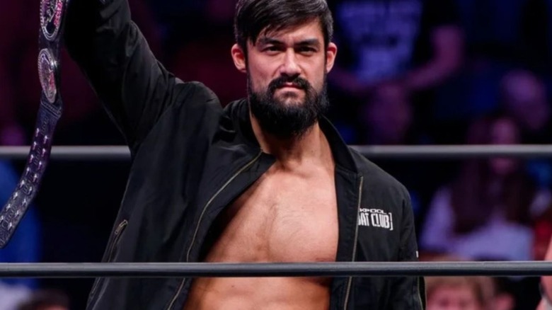 Wheeler Yuta holds up the ROH Pure Championship in the ring during an episode of AEW TV.