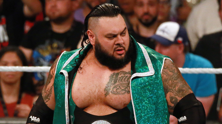Bronson Reed wearing a long, green vest