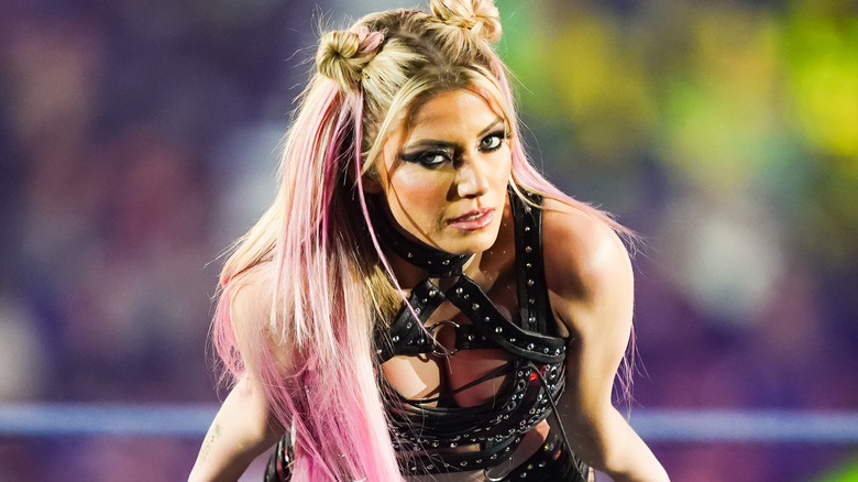 Alexa Bliss leaning against the ring ropes