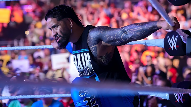 Jey Uso stretching his arms on the ropes