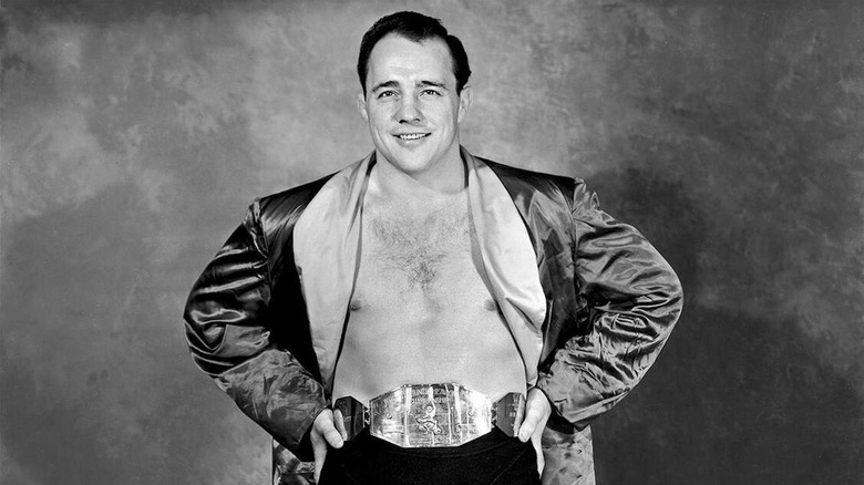 Verne Gagne poses with a title belt