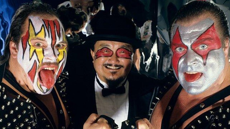Demolition's Smash and Ax posing alongside Mr. Fuji.