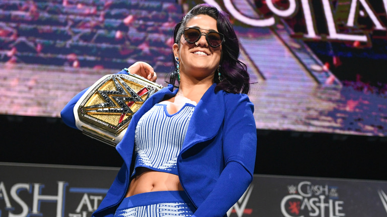 Bayley holding the WWE Women's Championship on her shoulder