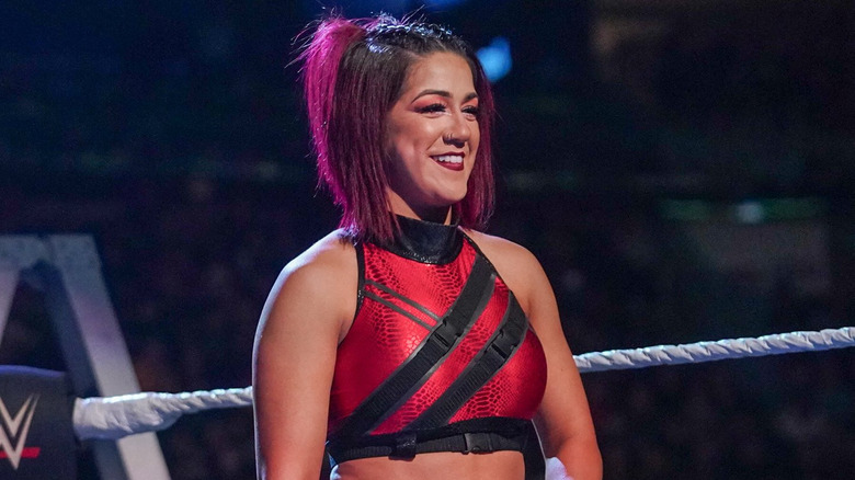 Bayley grinning in red