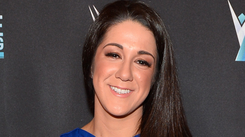 Bayley smiling in a blue dress