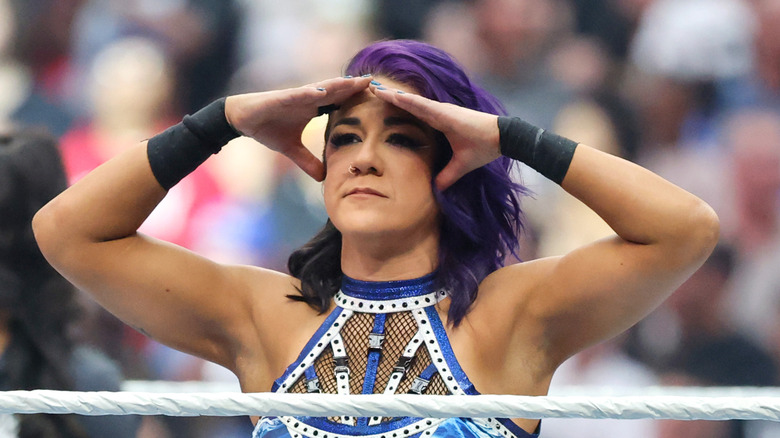 Bayley using both hands to look out into the crowd