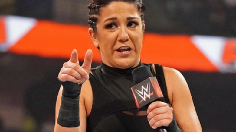 Bayley talking into a mic and pointing WWE