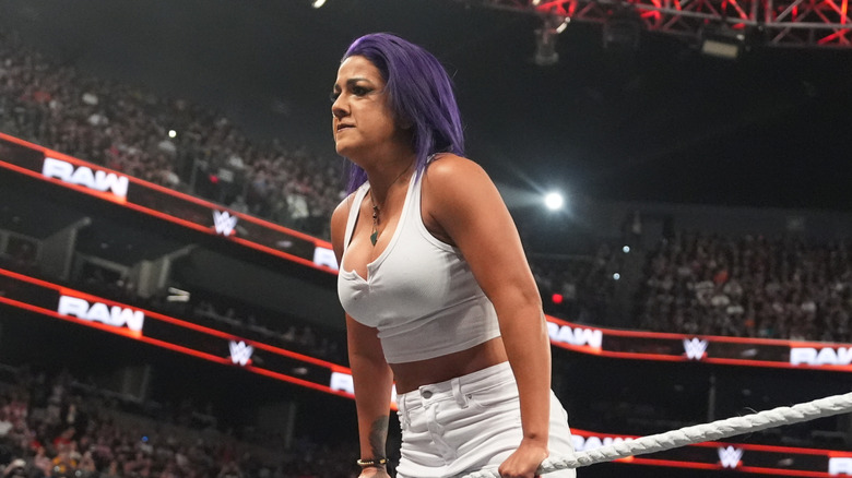 Bayley leans against the ropes