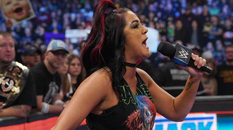 Bayley shouts into the microphone