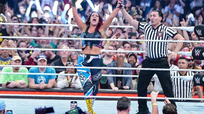 Bayley has her hand raised by a referee in the ring after winning the 2024 Women's Royal Rumble.