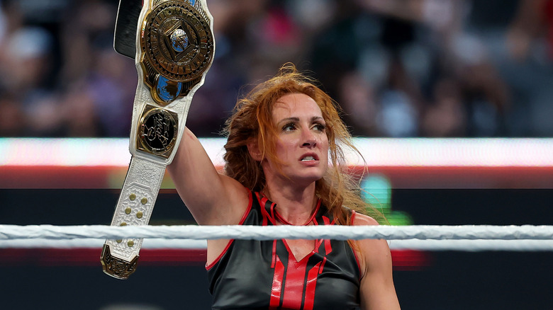 Becky Lynch holding the WWE Women's IC Championship belt