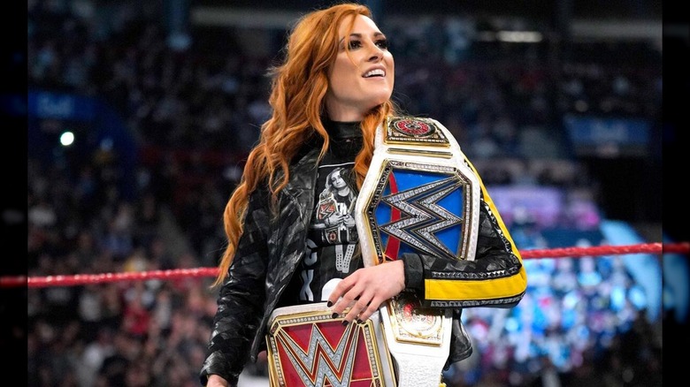 Becky Lynch with both the SmackDown and RAW Women's Championships during her reign with both titles.