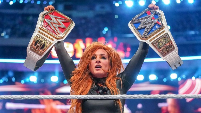 Minutes after capturing the WWE Raw and SmackDown Women's Championships, Becky Lynch takes in the emotional moment by holding both titles in the air at WrestleMania 35