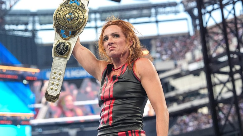 Becky Lynch holding the Women's WWE Intercontinental Championship above her head after successfully defending it at SummerSlam 2025.