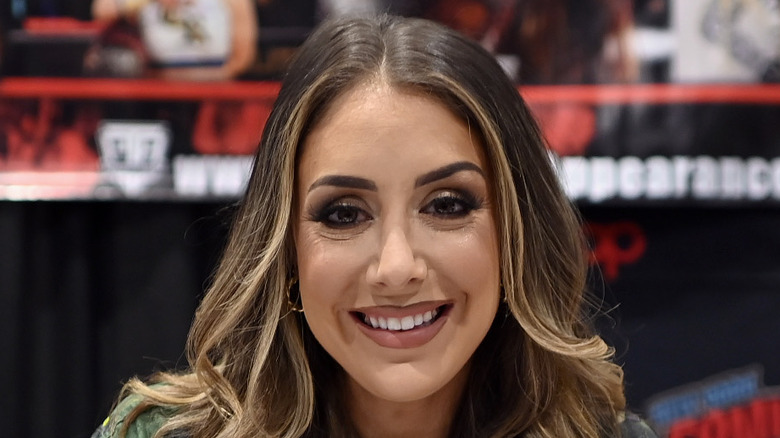 Britt Baker smiling during an autograph signing