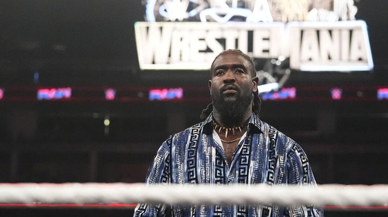 Oba Femi stands in the ring, the WrestleMania sign behind him, during a segment on "WWE Raw."