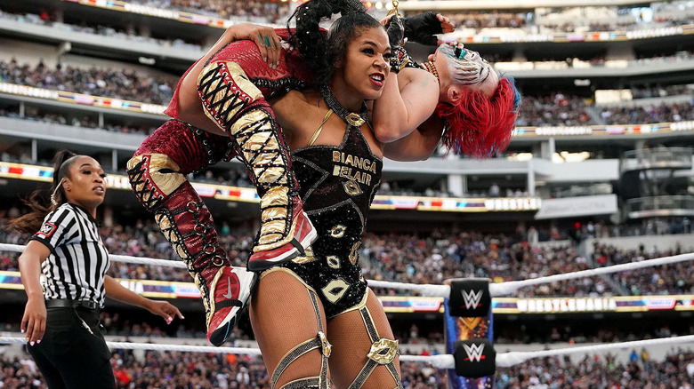 Bianca Belair with Asuka on her shoulders 