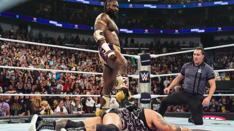 Oba Femi stands with his foot on Bronson Reed's back in the middle of the ring after his victory at WWE Money in the Bank 2026.