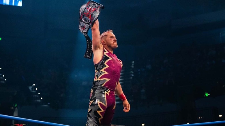 Amazing Red holds up the X-Division title