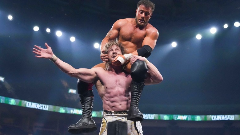 Kenny Omega with MJF on his shoulders at AEW Dynasty