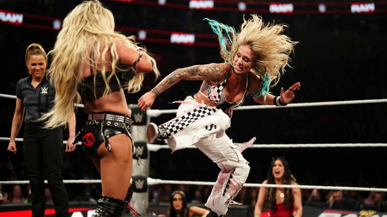 Sol Ruca delivers a kick to Women's World Champion Liv Morgan during a match on "WWE Raw," as referee Jessika Carr, Roxanne Perez, and Raquel Rodriguez look on.