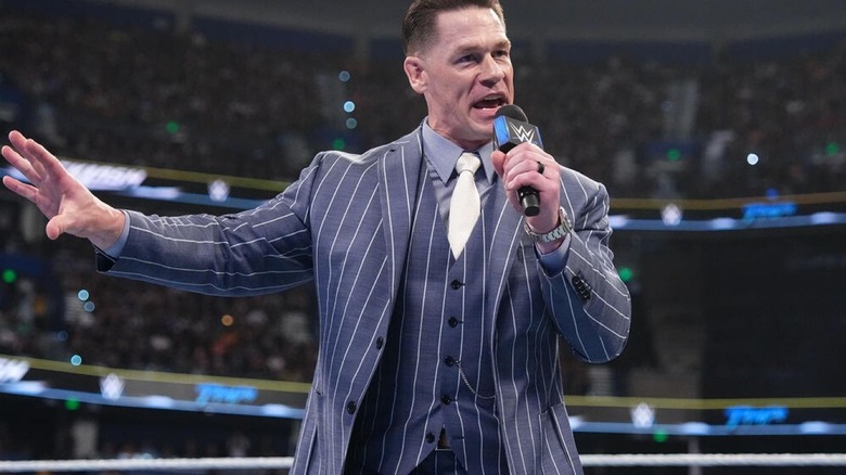 John Cena gestures while speaking into a microphone at WWE Backlash