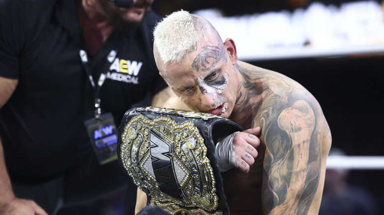AEW World Champion Darby Allin clutches the belt in the ring after a victory over PAC at "AEW Collision: Fairway to Hell."