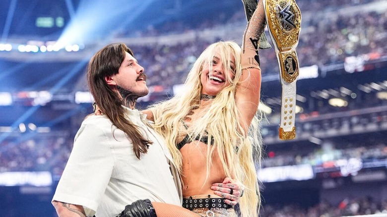 Dominik Mysterio holds up new Women's World Champion Liv Morgan after her victory over Stephanie Vaquer at WWE WrestleMania 42.
