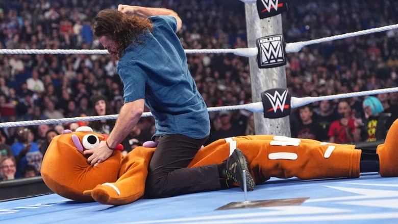 Sami Zayn punches a life-sized gingerbread man costume in the ring during a promo segment on "WWE SmackDown."