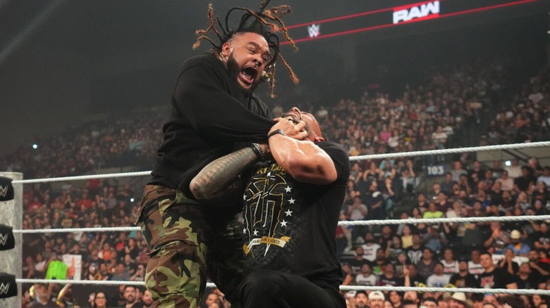 Jacob Fatu locks in a Tongan Death Grip on World Heavyweight Champion Roman Reigns in the ring during an episode of "WWE Raw."