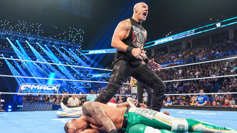 Baron Corbin screams while standing above a fallen Carmelo Hayes on "WWE SmackDown"