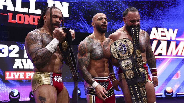 Bishop Kaun, Ricochet, and Toa Liona pose with their AEW World Trios Championships after defeating The Conglomeration on the July 29, 2026 episode of "AEW Dynamite."