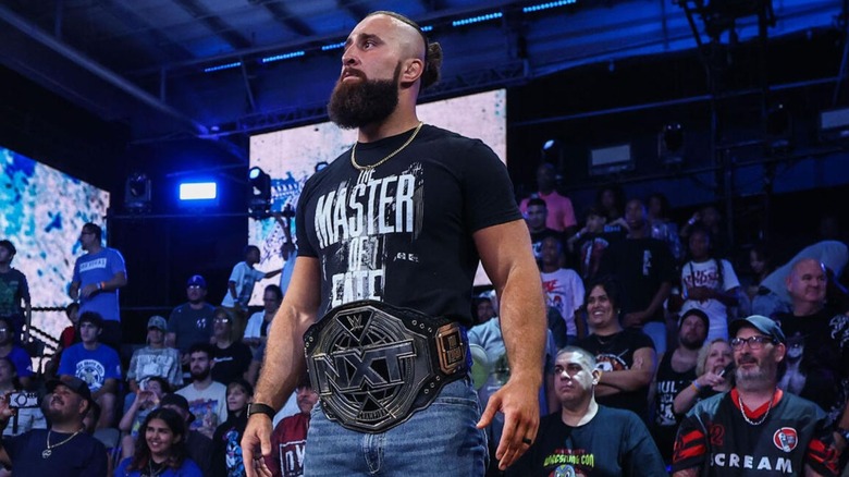 NXT Champion Tony D'Angelo stands on top of the commentary desk and looks toward the ring during the main event segment of "WWE NXT" on August 18, 2026.