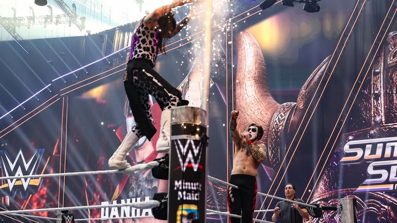 Danhausen hits his curse pose, causing pyro to go off in the corner, blinding Dominik Mysterio, during their Human Monies on a Pole match at WWE SummerSlam 2026.
