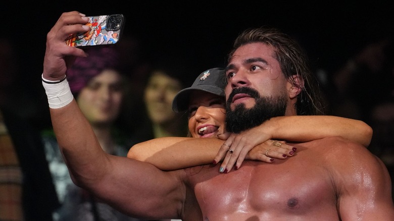 Andrade poses with a fan on "AEW Dynamite"