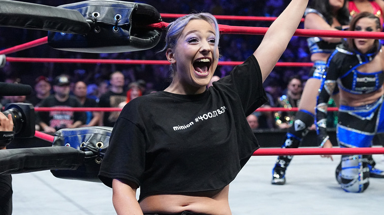 Billie Starkz celebrates on the ring apron
