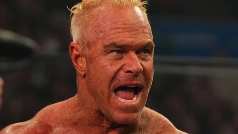 Billy Gunn speaks to an opponent in the ring in a close-up shot of his face during a match on AEW programming.