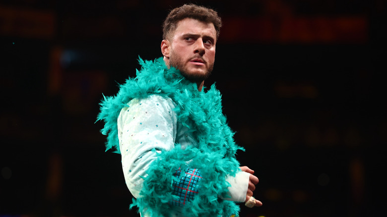 MJF looks to the crowd in the ring, still wearing his ring robe, before his AEW World Championship match against Adam Page at Forbidden Door.