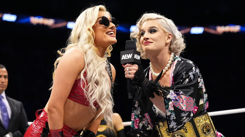 Mariah May, dresses as Toni Storm's rocker gimmick, cuts a promo with "Timeless Toni Storm in the ring during an episode of "AEW Dynamite."