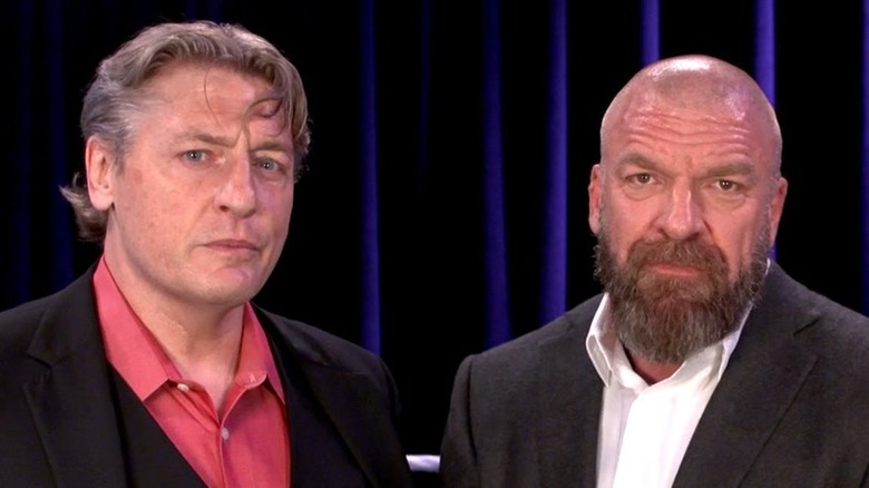 William Regal and Triple H look at camera