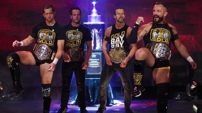 The Undisputed Era (Kyle O'Reilly, Roderick Strong, Adam Cole, and Bobby Fish) at the top of the ramp posing with all NXT's Men's Championships.