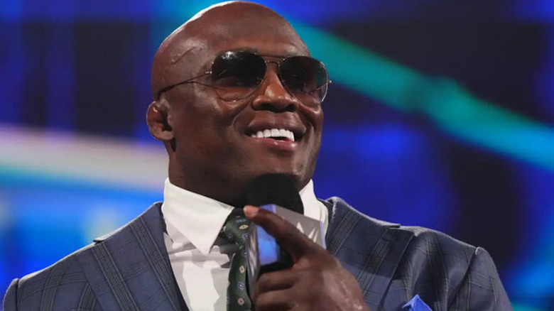 Bobby Lashley smiles while talking on the microphone.