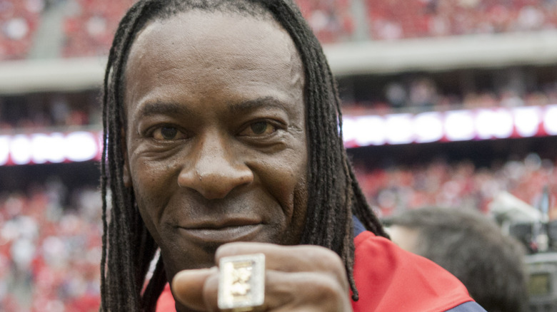 Booker T smiling with his WWE HoF ring