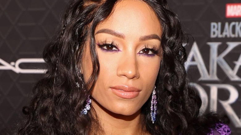 Sasha Banks wearing dangling earrings