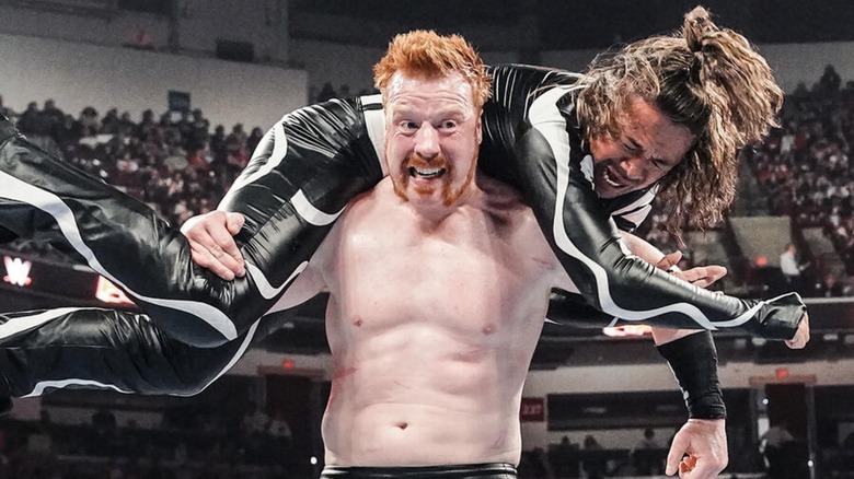Sheamus holding Shinsuke Nakamura over his head
