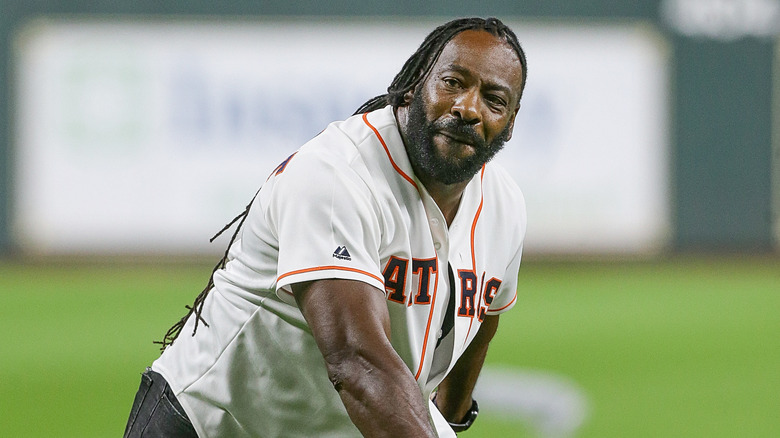 Booker T admires the baseball he just threw